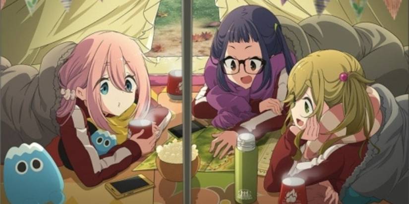 Nadeshiko, Aoi and Chiaki looking at a map together in their tent in Laid-Back Camp.