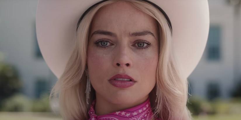 A close-up of Margot Robbie crying in Barbie while wearing a cowgirl outfit in Barbie