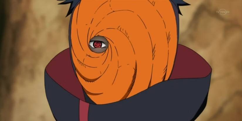 Obito Uchiha's sharingan is seen through his orange mask in Naruto: Shippuden.