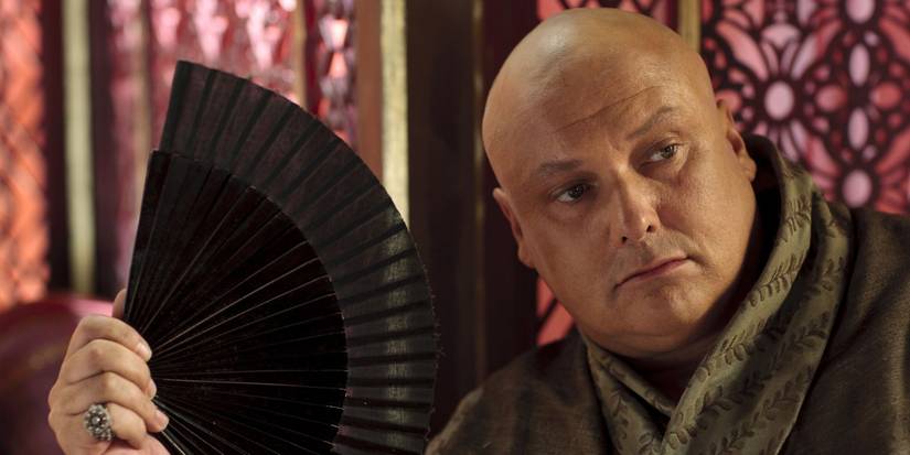 Varys (Conleth Hill) holding an ornate fan in Game of Thrones