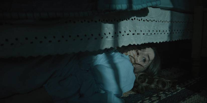 Brynn hiding under her bed in No One Will Save You