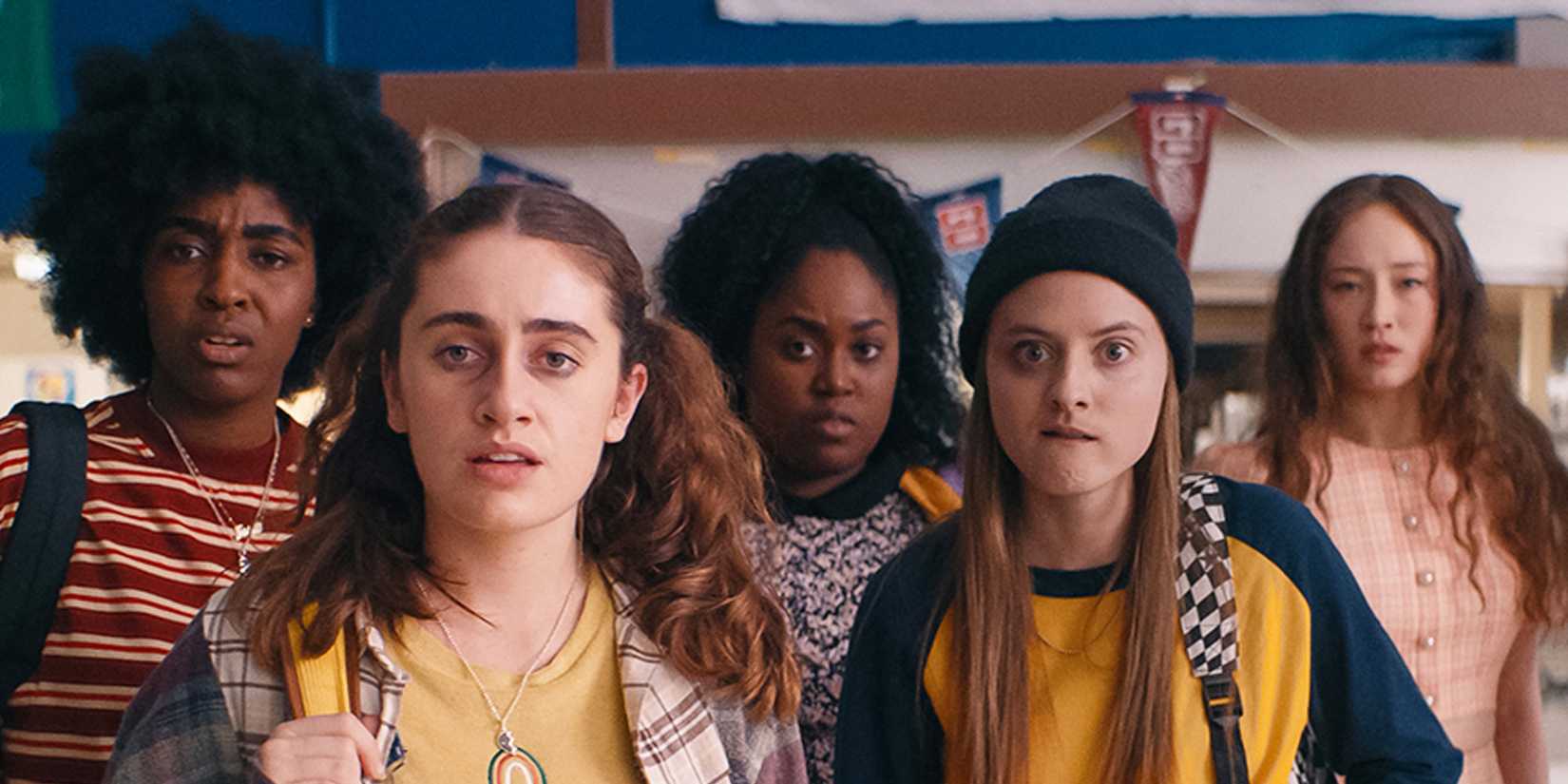 A group of high school girls of the fight club in Bottoms stand together in the gym.