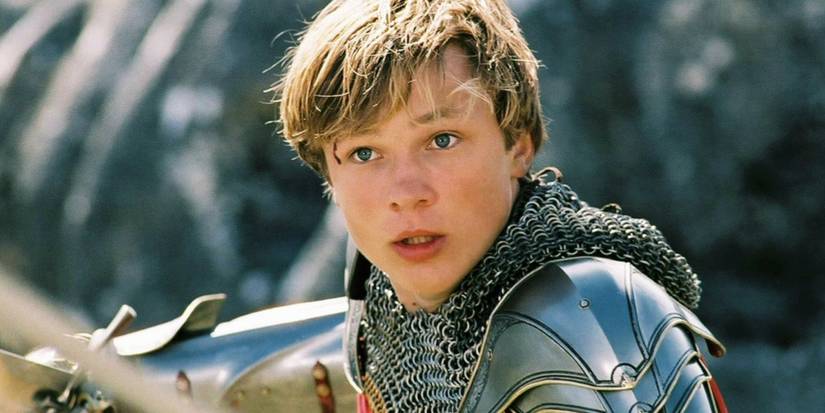Peter Pevensie holds a sword in The Chronicles of Narnia.