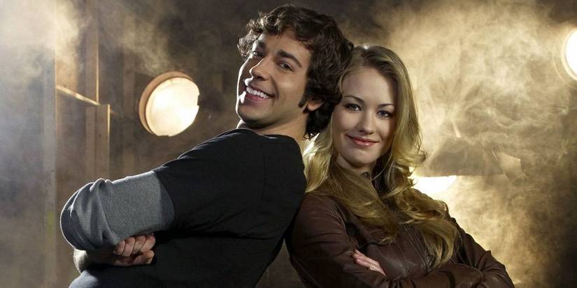 Chuck (Zachary Levi) and Sarah (Yvonne Strahovski) pose back to back, smiling