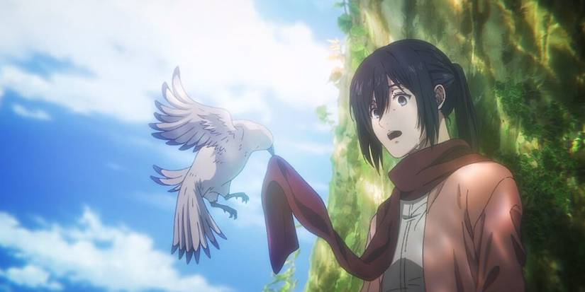 Mikasa looks surprised as a bird picking up her red scarf in Attack On Titan.