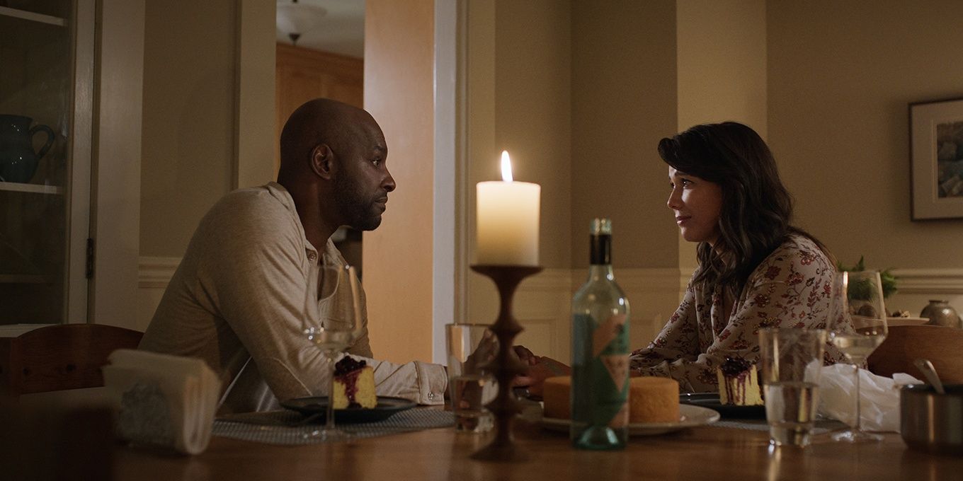 Preacher and Paige at a table in Virgin River 