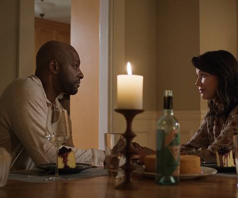 Preacher and Paige at a table in Virgin River