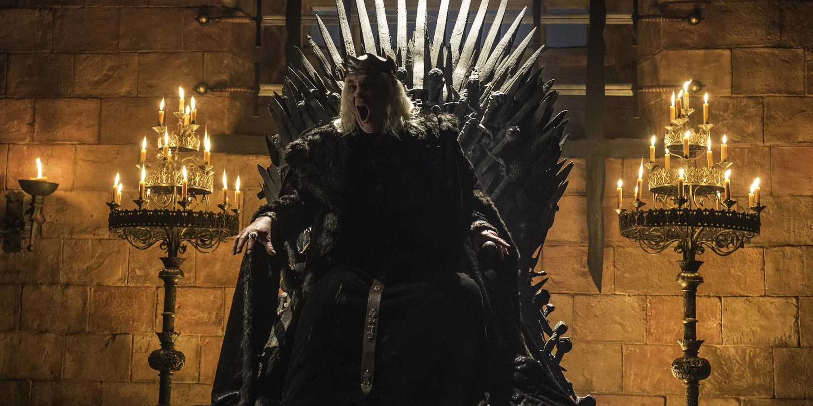 Aerys II Targaryen, The Mad King, from Game of Thrones sits on the throne.