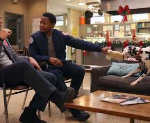 Alberto Rosende as Blake Gallo sits with Daniel Kyri as Darren Ritter and interacts with Tuesday the dog on Chicago Fire