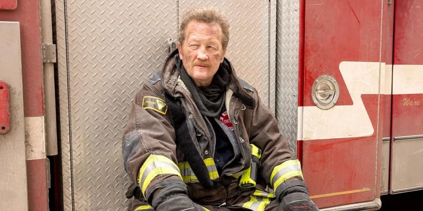 Christian Stolte leans against a fire truck as Randall 'Mouch' McHolland on Chicago Fire