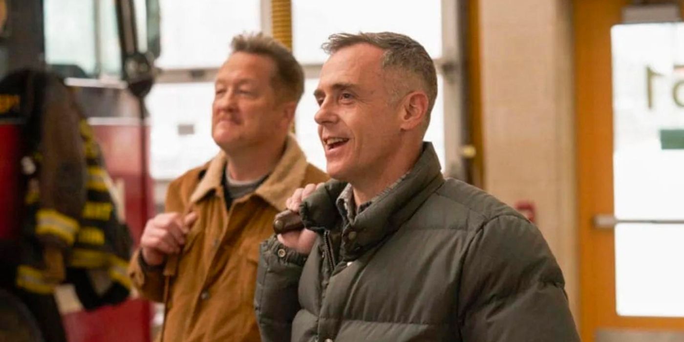 David Eigenberg as Christopher Herrmann stands in front of Christian Stolte as Randall 'Mouch' McHolland on Chicago Fire