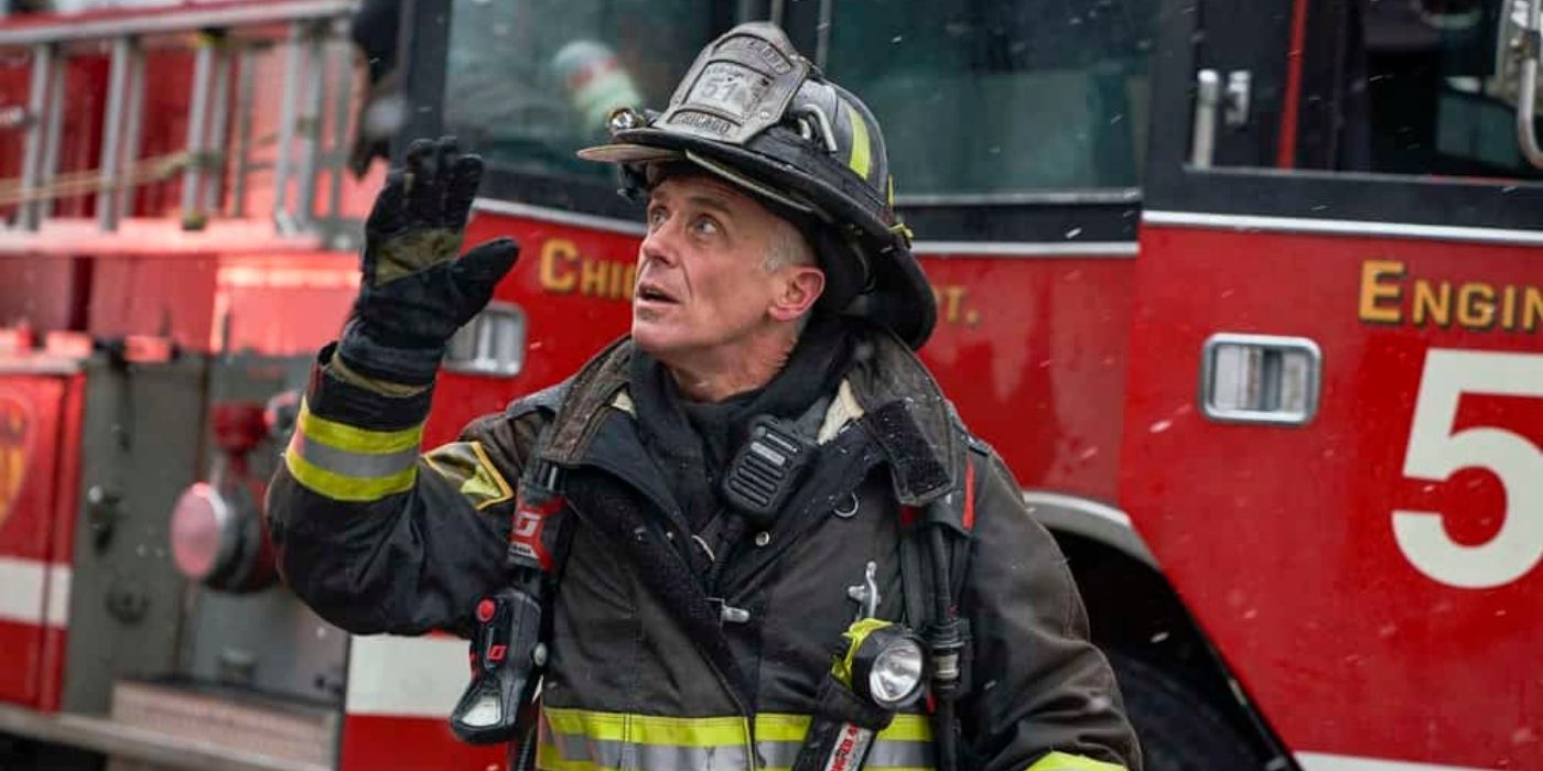 David Eigenberg looks up at a building as Christopher Herrmann on Chicago Fire
