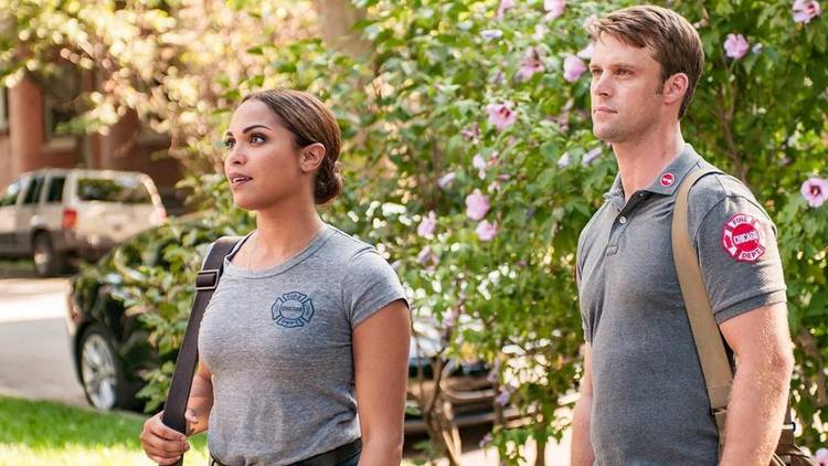 Monica Raymund as Gabriela Dawson stands with Jesse Spencer as Matthew Casey on Chicago Fire