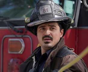 Yuri Sardarov stands in front of a fire truck as Brian 'Otis' Zvonecek on Chicago Fire