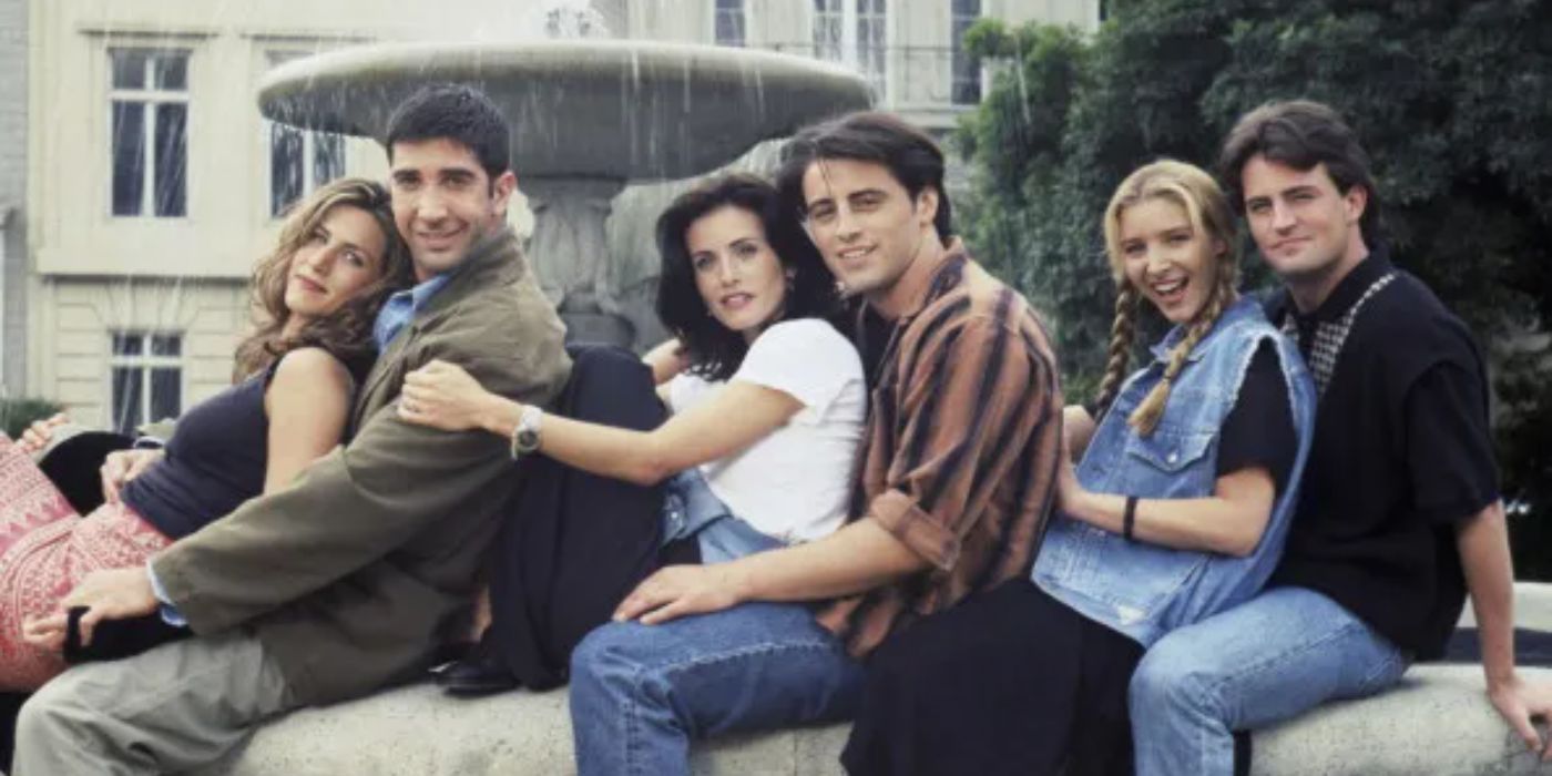 Friends cast united by a fountain.