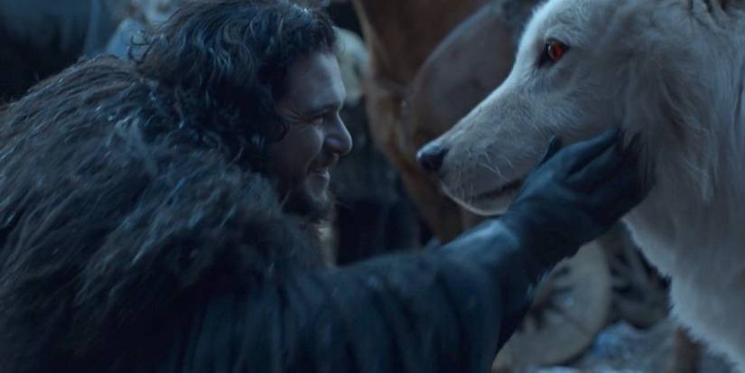 Jon Snow pets Ghost in Game of Thrones.