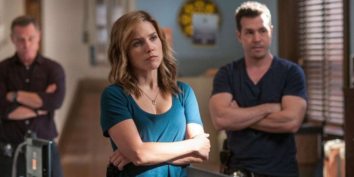 Sophia Bush as Erin Lindsay stands in the intelligence room with Jon Seda as Antonio Dawson and Jason Beghe as Hank Vought behind her on Chicago P.D