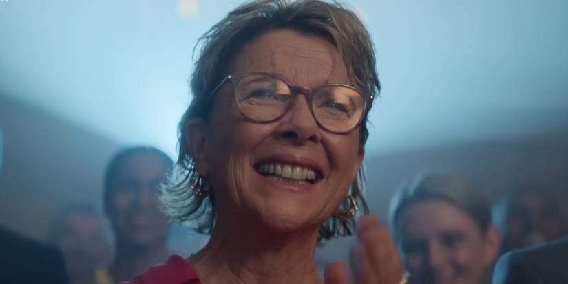 Annette Bening as Joy Delaney smiling and clapping at a video in Apples Never Fall.