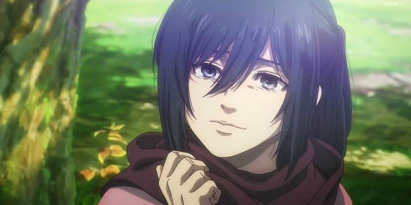 Mikasa smiling sadly and holding her scarf in Attack on Titan