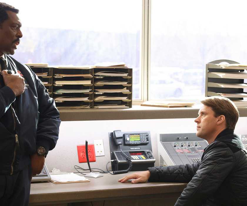 Boden (Eamonn Walker) talks to Casey (Jesse Spencer) at a desk in Chicago Fire Season 12, Episode 6