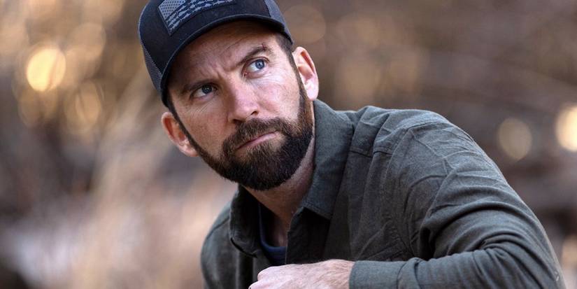 Lucas Black as Christopher LaSalle looks up from where he squats in NCIS: New Orleans