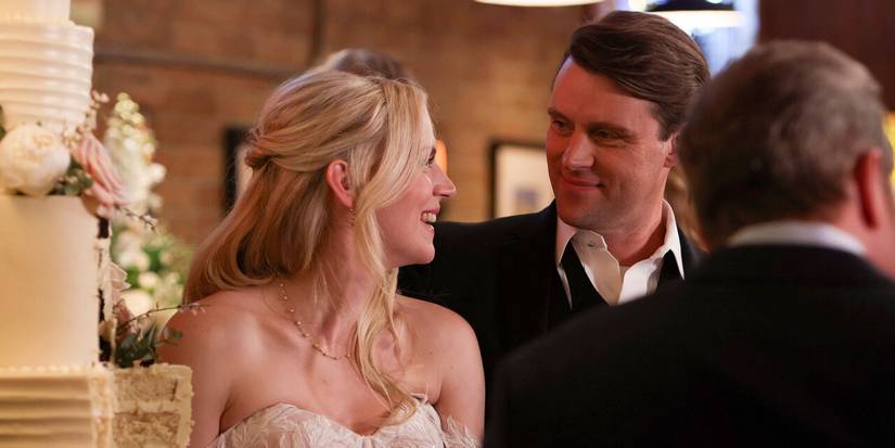 Kara Killmer as Sylvie Brett and Jesse Spencer as Matt Casey look at each other next to a wedding cake on Chicago Fire