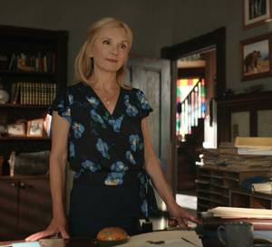 Muriel stands at Doc's desk in Virgin River