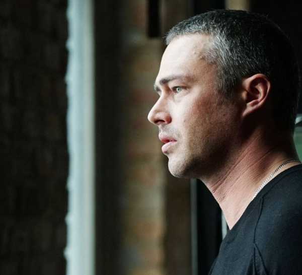 Taylor Kinney as Kelly Severide looking out a window in Chicago Fire episode "Carry Me"