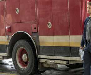 Jesse Spencer as Matthew Casey standing next to firetruck in Chicago Fire episode "Carry Me"