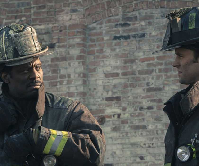 Boden (Eamonn Walker) and Casey (Jesse Spencer) standing outside of a building in Chicago Fire "Deathtrap"