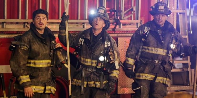 Otis, Herrmann and Cruz in firefighter gear, next to fire truck, looking up in Chicago Fire