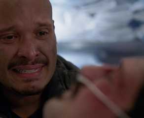 Joe Minoso as Firefighter Joe Cruz at the hospital bed of Yuri Sardarov as Firefighter Brian "Otis" Zvonecek in Chicago Fire in episode "Sacred Ground "