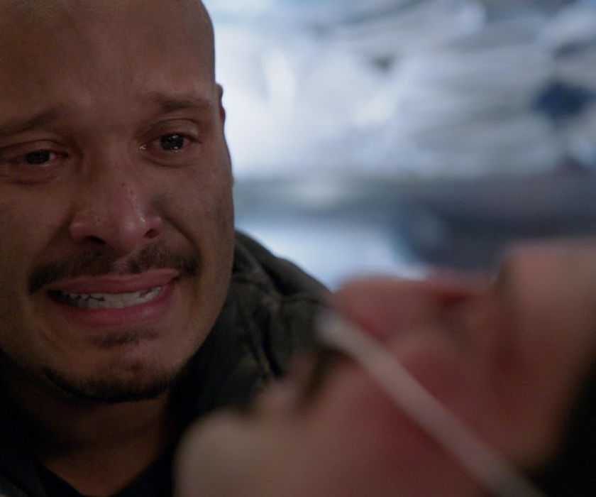 Joe Minoso as Firefighter Joe Cruz at the hospital bed of Yuri Sardarov as Firefighter Brian "Otis" Zvonecek in Chicago Fire in episode "Sacred Ground "