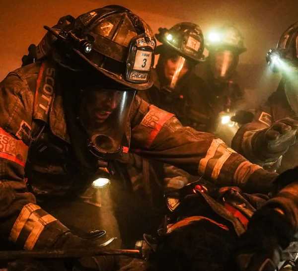 Joe Minoso as Firefighter Joe Cruz with his fellow firefighters recovering the body of Brian 'Otis' Zvonecek in Chicago Fire episode "Sacred Ground"
