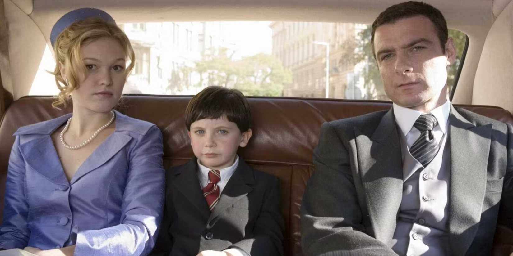 Damien sits with his parents, Katherine and Robert in The Omen (2006)