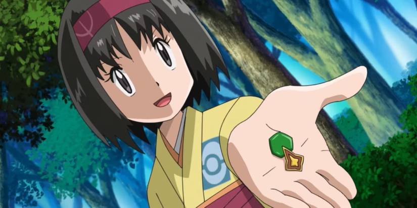 Erika smiling and holding out the Rainbow Badge in the Pokémon anime.