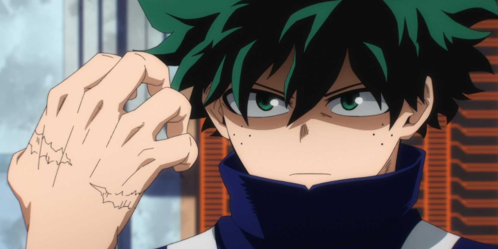 Deku looks serious while holding up his scarred hand in My Hero Academia.