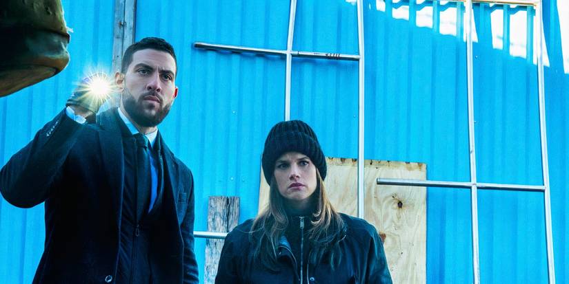 FBI Special Agent Omar Adom 'OA' Zidan (Zeeko Zaki) and Maggie Bell (Missy Peregrym) investigate a crime scene while OA holds a flashlight