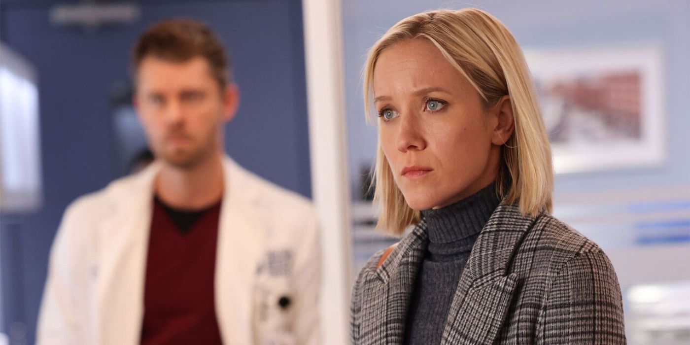 Jessy Schram as Hannah Asher waits for information with Luke Mitchell as Mitch Ripley standing behind her on Chicago Med