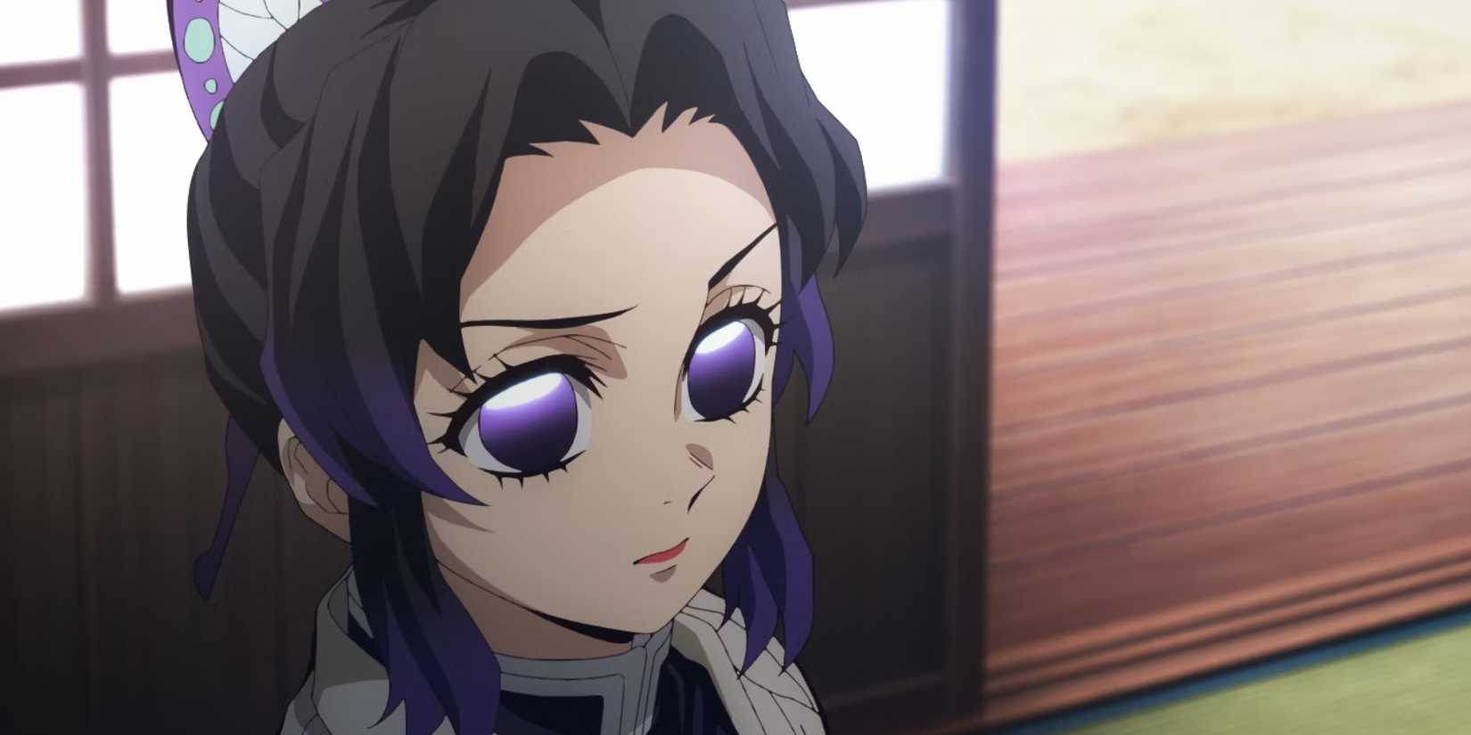 Shinobu Kocho makes a serious face while sitting inside.