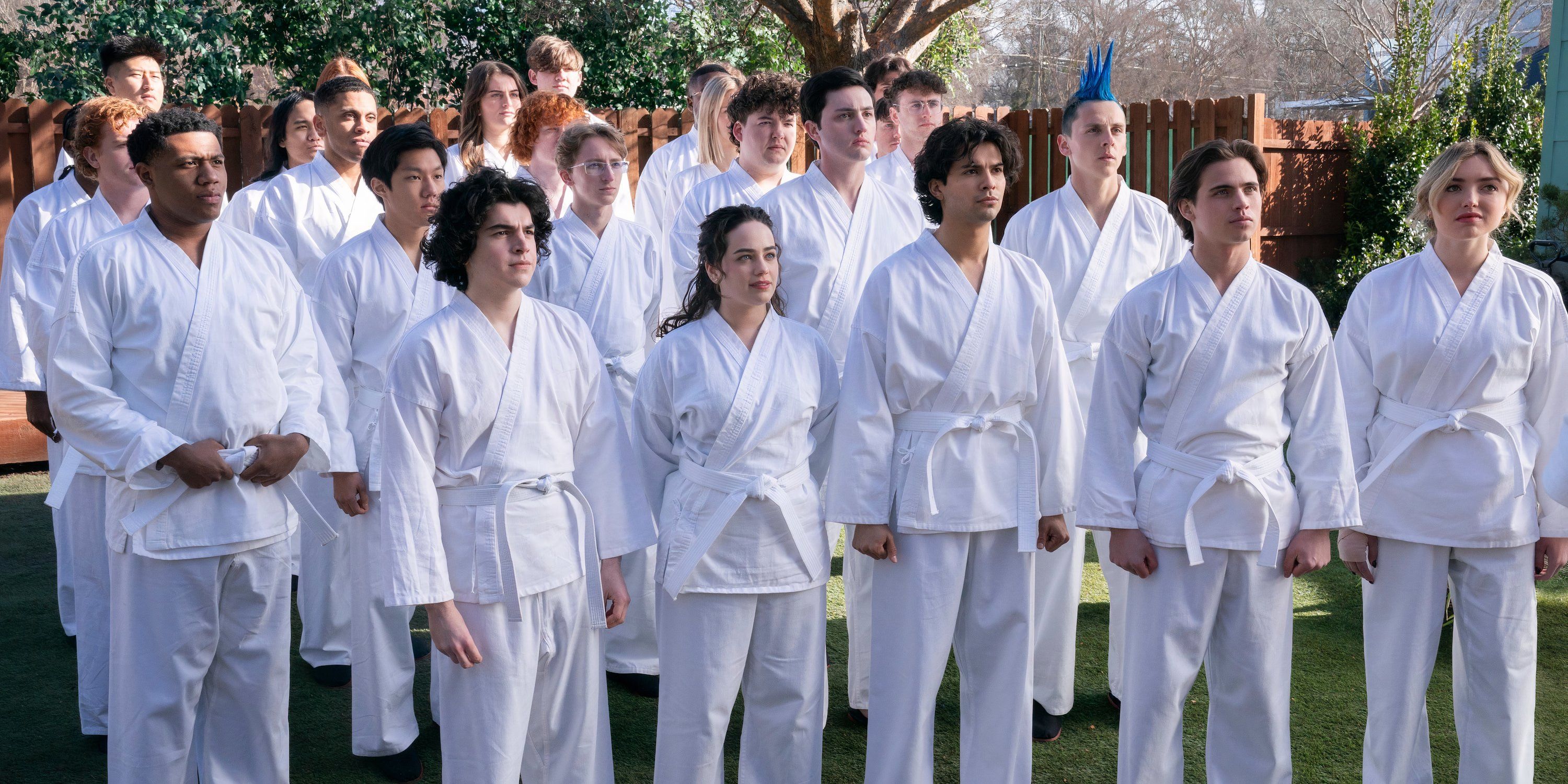 Eagle Fang and Miyagi-do students stand together in karate gis in Cobra Kai Season 6