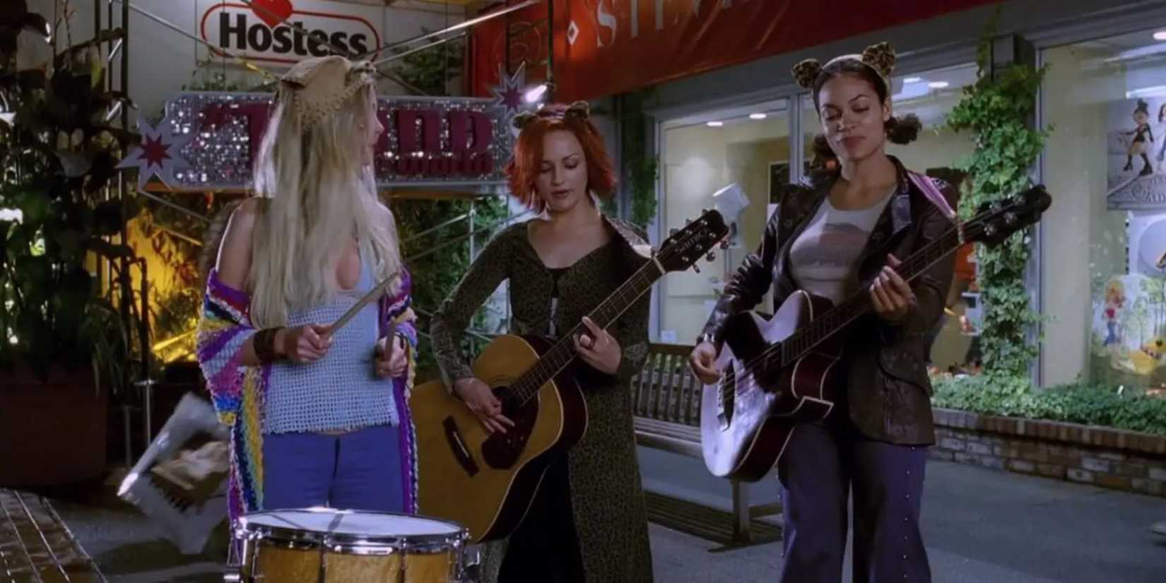 Josie McCoy, Melody Valentine and Valerie Brown play a song on the street in Josie and the Pussycats.