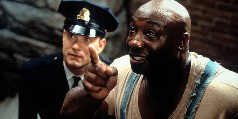 Paul listens to John Coffey as he points up in The Green Mile