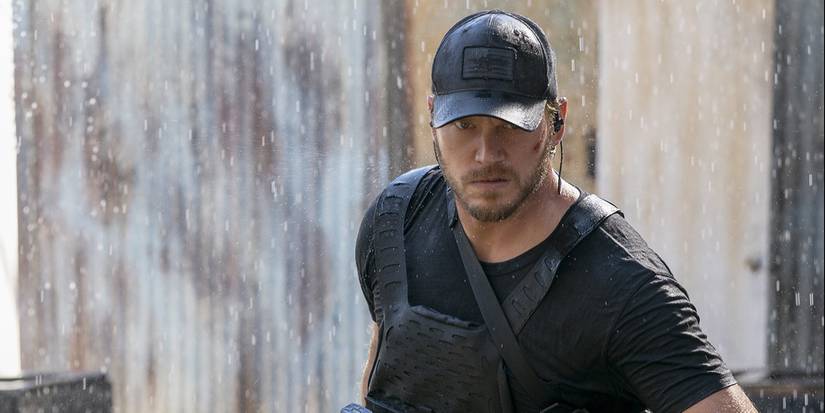 Chris Pratt in The Terminal List dragging something along the ground looking angry.