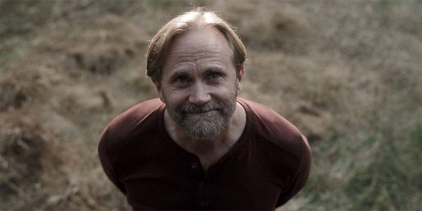 Colter's father looking up to the sky and smiling on Tracker.