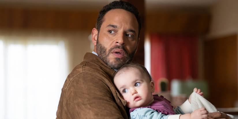 Daniel Sunjata as Adam Karadec holds baby Chloe on High Potential.