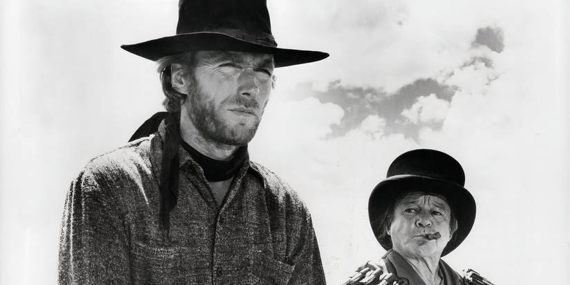 Clint Eastwood as The Stranger and Billy Curtis as Mordecai preparing to face the outlaws ahead in High Plains Drifter.