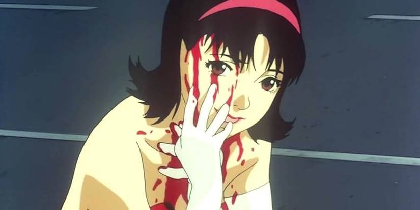 The "fake" Mima crouches on the street and serenely smiles, smearing her face with blood in Perfect Blue