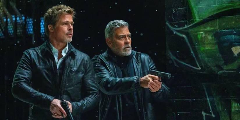 Brad Pitt and George Clooney wearing black leather jackets and holding guns in the movie Wolfs