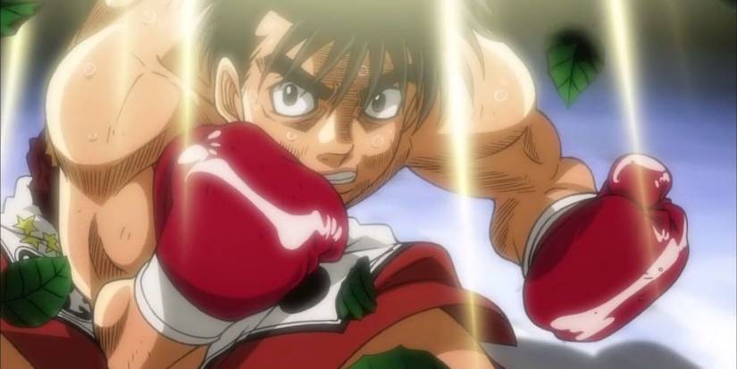 Ippo is crouching and looking angry while fighting in a boxing match in Hajime no Ippo: Fighting Spirit.